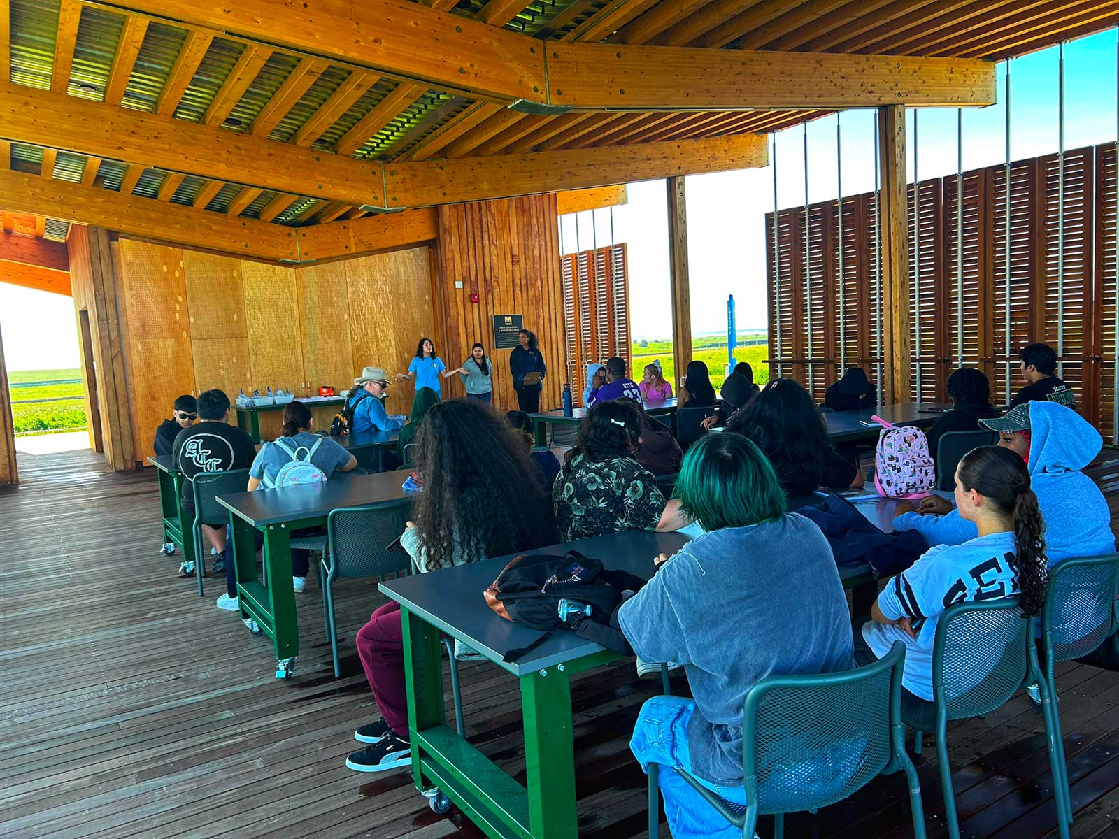 Students and researchers gathered in the open-air Field Center classroom